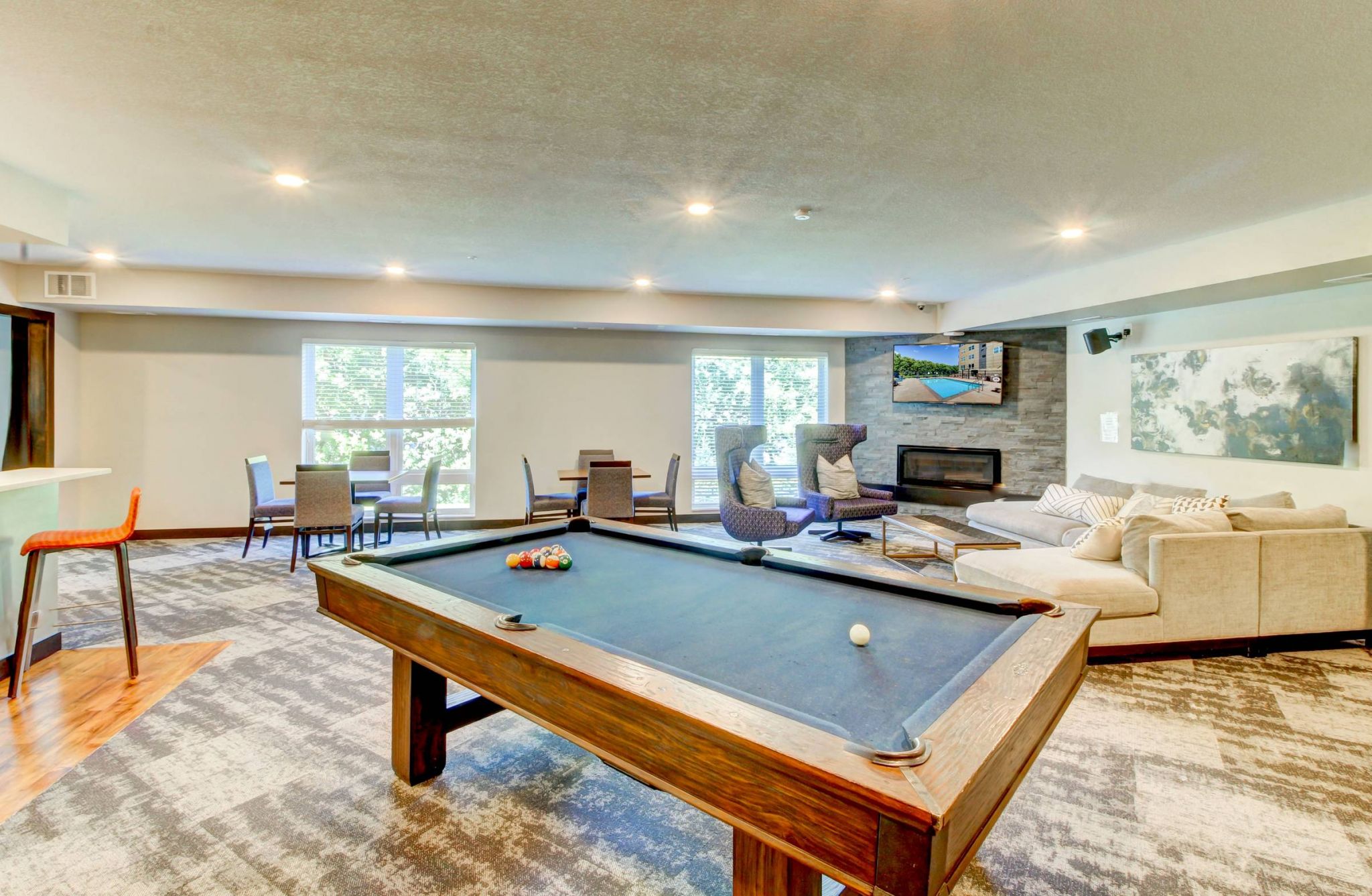 Viiridian Central Clubhouse A well-equipped game room with a pool table and bar, designed for entertainment and unwinding with friends.