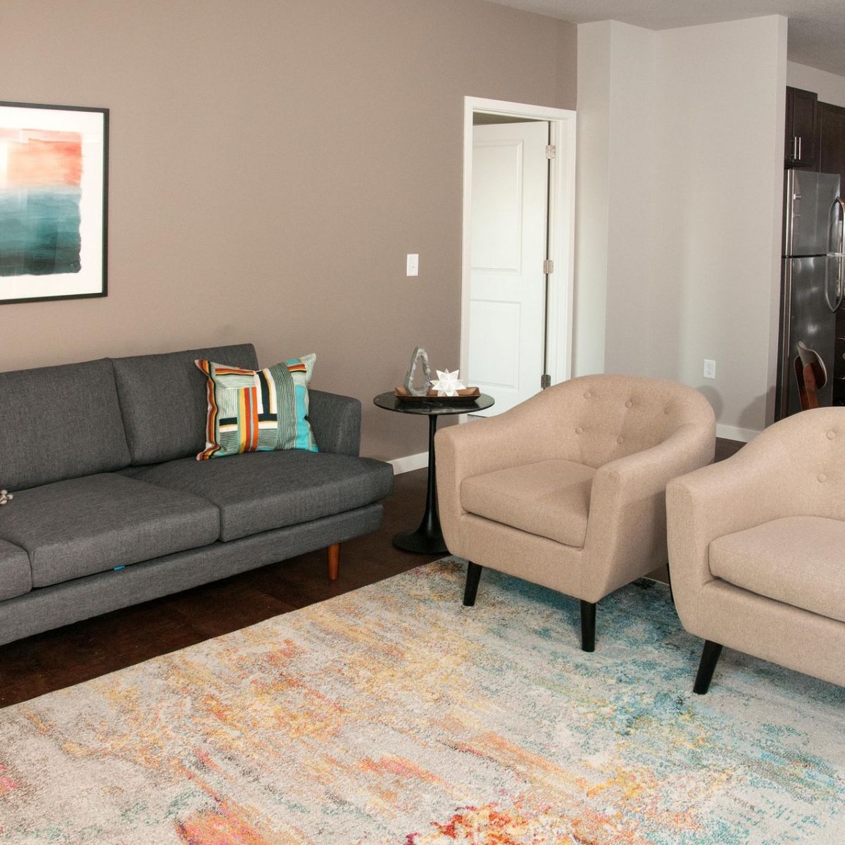 Viridian Central A charming living room arrangement with two contemporary chairs and a soft couch, ideal for leisure and conversation.