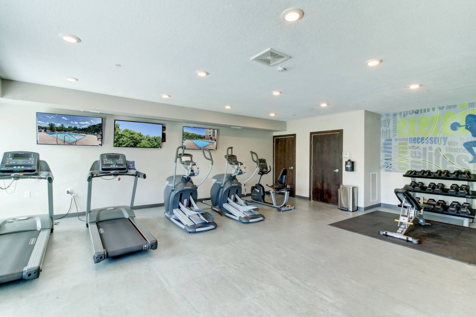 Viridian Central A gym room with treadmills and exercise equipment.